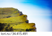 Etretat famous green grass cliffs over blue sky (2017 год). Стоковое фото, фотограф Сергей Новиков / Фотобанк Лори