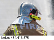 Back view of inscription Fire on uniform firefighter Emercom of Russia, Ministry of Civil Defence, Emergencies and Disaster Relief Russian Federation MChS (2019 год). Редакционное фото, фотограф А. А. Пирагис / Фотобанк Лори