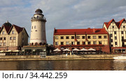 KALININGRAD, RUSSIA - JULY 29, 2020: Fish village district with a lighthouse on the bank of the Staraya Pregolya river in the rays of the setting sun. Kaliningrad, Russia. Редакционное видео, видеограф Алексей Кузнецов / Фотобанк Лори