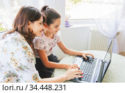 A school girl with the help of her mother is engaged in a remote program. Стоковое фото, фотограф Владимир Ушаров / Фотобанк Лори