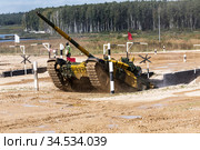 Moscow region, polygon "Alabino". The international army games - 2020. Tank biathlon. A tank with a kazakhstan crew overcomes an obstacle antitank ditch. Редакционное фото, фотограф Наталья Волкова / Фотобанк Лори