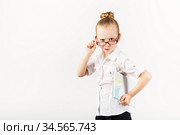 Funny smiling little girl imitates a strict teacher against white background. Стоковое фото, фотограф Nataliia Zhekova / Фотобанк Лори