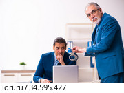 Male employee and cop in police investigation concept. Стоковое фото, фотограф Elnur / Фотобанк Лори