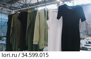 Clothing production - examples of dresses hang on hangers. Стоковое видео, видеограф Константин Шишкин / Фотобанк Лори