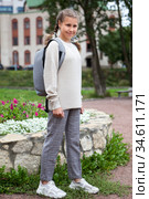 Pre-teen girl a student in grade 6 goes back to school at September, full-length portrait with backpack on her back. Стоковое фото, фотограф Кекяляйнен Андрей / Фотобанк Лори