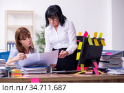 Two female employees and excessive work in the office. Стоковое фото, фотограф Elnur / Фотобанк Лори