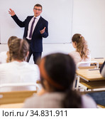 Male teacher lecturing to students at classroom. Стоковое фото, фотограф Яков Филимонов / Фотобанк Лори