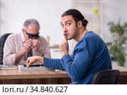 Young man visiting old male jeweler. Стоковое фото, фотограф Elnur / Фотобанк Лори