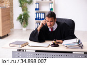 Young male lawyer working in the courthouse. Стоковое фото, фотограф Elnur / Фотобанк Лори