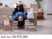 Young male student preparing for exams at home. Стоковое фото, фотограф Elnur / Фотобанк Лори