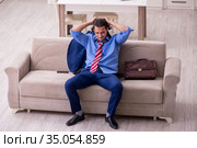 Young male employee being fired from his work at home. Стоковое фото, фотограф Elnur / Фотобанк Лори
