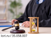 Young male judge in time management concept. Стоковое фото, фотограф Elnur / Фотобанк Лори