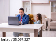 Girl bothering young father during working from house in pandemi. Стоковое фото, фотограф Elnur / Фотобанк Лори