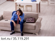 Young male employee being fired from his work at home. Стоковое фото, фотограф Elnur / Фотобанк Лори