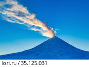 Winter eruption active Klyuchevskoy Volcano at beauty golden hour. Plume of gas, ash from crater, illuminated rays setting sun. Стоковое фото, фотограф А. А. Пирагис / Фотобанк Лори