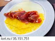 Carpaccio of pineapple and melon carpaccio with thinly sliced prosciutto. Стоковое фото, фотограф Яков Филимонов / Фотобанк Лори