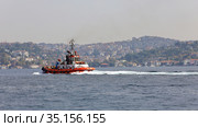 Red ship in the Bosphorus Strait. View of the Asian side. City of Istanbul, Turkey. (2020 год). Редакционное фото, фотограф Bala-Kate / Фотобанк Лори