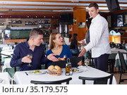 Couple dissatisfied with service of restaurant. Стоковое фото, фотограф Яков Филимонов / Фотобанк Лори