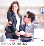 Sexual harassment concept with man and woman in office. Стоковое фото, фотограф Elnur / Фотобанк Лори