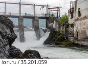 CHEMAL, RUSSIA - 24 JULY, 2019: Hydroelectric power plant on the Chemal river in the village of Chemal of the Altai Republic, Russia. Built in 1935, decommissioned in 2011. Стоковое фото, фотограф Сергей Фролов / Фотобанк Лори