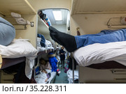 Male legs in black socks in the aisle of a train car. Стоковое фото, фотограф Володина Ольга / Фотобанк Лори