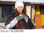 Caucasian woman in woollen gloves holds a paper cup of coffee in the winter city outdoors. Hot and warming beverage in the winter season. Стоковое фото, фотограф Кекяляйнен Андрей / Фотобанк Лори