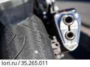 Punctured motorcycle wheel with a nail sticks out of the tire, close-up view. Стоковое фото, фотограф Кекяляйнен Андрей / Фотобанк Лори