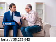 Young male lawyer visiting old man in testament concept. Стоковое фото, фотограф Elnur / Фотобанк Лори
