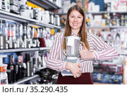 Smiling girl seller showing liquidiser in shop. Стоковое фото, фотограф Яков Филимонов / Фотобанк Лори