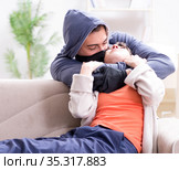 Armed man assaulting young woman at home. Стоковое фото, фотограф Elnur / Фотобанк Лори