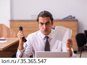Young male employee unhappy with office prank in the office. Стоковое фото, фотограф Elnur / Фотобанк Лори