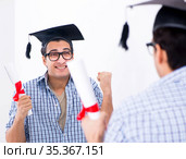 Young student planning graduation speech in front of mirror. Стоковое фото, фотограф Elnur / Фотобанк Лори