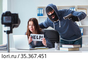 Criminal recording message for ransom with victim businesswoman. Стоковое фото, фотограф Elnur / Фотобанк Лори
