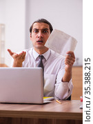 Young male employee unhappy with office prank in the office. Стоковое фото, фотограф Elnur / Фотобанк Лори