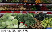 Large assortment of fresh colorful fruits and vegetables in wicker trays on shelves in supermarket. Стоковое видео, видеограф Яков Филимонов / Фотобанк Лори
