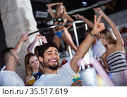 positive male joying and thumbs up on party in the club with coc. Стоковое фото, фотограф Яков Филимонов / Фотобанк Лори
