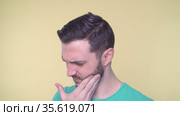 Young man with toothache in pain. Стоковое видео, видеограф Mihail Mihaylov / Фотобанк Лори