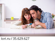 Young couple in unexpected pregnancy concept at home. Стоковое фото, фотограф Elnur / Фотобанк Лори