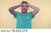 Excited, surprised bearded man keeping hands near face and shouting in amazement. Стоковое видео, видеограф Mihail Mihaylov / Фотобанк Лори