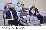 Side view of managers group in protective masks working at laptops in company office. Стоковое видео, видеограф Яков Филимонов / Фотобанк Лори