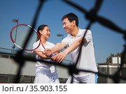 Young girl playing tennis with her coach . Стоковое фото, агентство Ingram Publishing / Фотобанк Лори