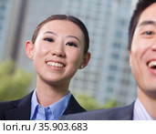 Portrait of two young business people outside in the business district, Beijing. Стоковое фото, агентство Ingram Publishing / Фотобанк Лори