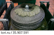 Process of forming stack of fiber mats with milled olive paste, preparing to press on artisanal olive oil factory. Стоковое видео, видеограф Яков Филимонов / Фотобанк Лори
