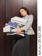Businesswoman struggling with heavy files. Стоковое фото, фотограф Shannon Fagan / Ingram Publishing / Фотобанк Лори