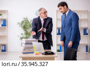 Two male employees working in the office. Стоковое фото, фотограф Elnur / Фотобанк Лори