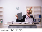 Funny young male employee magician and too much work in the office. Стоковое фото, фотограф Elnur / Фотобанк Лори