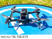 Moscow Russia - 30 may 2021: Close-up picture new aerial DJI FPV drone on fly landing pad. Top front view uav quad copter with 4K 60 fps Digital Camera and Remote control. travel in sunny summer day. Редакционное фото, фотограф Алексей Ширманов / Фотобанк Лори