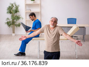 Old male patient visting young male doctor radilogist. Стоковое фото, фотограф Elnur / Фотобанк Лори