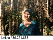 Young woman in folk peasant clothes in the coniferous forest. Стоковое фото, фотограф Евгений Харитонов / Фотобанк Лори