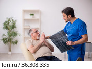 Old male patient visting young male doctor radilogist. Стоковое фото, фотограф Elnur / Фотобанк Лори